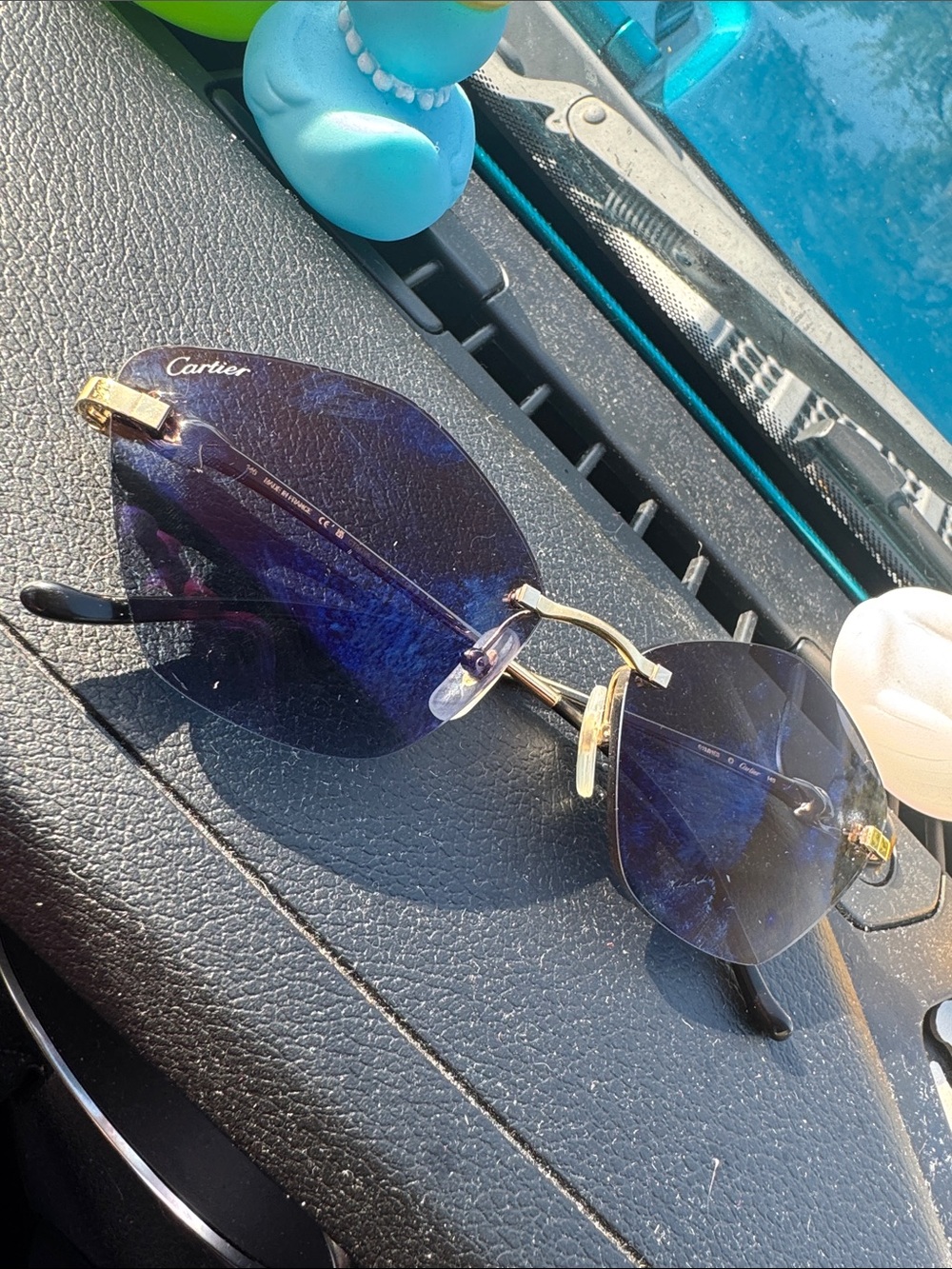 Cartier Rimless Sunglasses with Deep Blue Lenses and Gold Accents